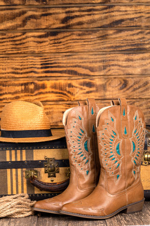 Travel stuff set for travel, vintage suitcase, boots and hat. Travel goods as a concept idea. Space for text.の写真素材