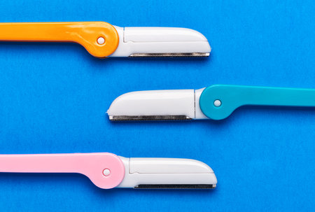 multicolored razor shavers. Colored razors shavers, on a blue background. copy space for text. view from above.の写真素材
