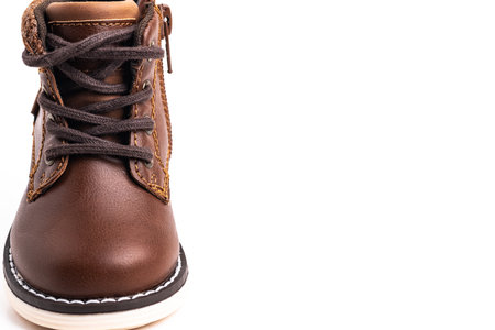 One brown children's shoe made of leather for a boy on a white background. Space for text. close-up.の写真素材