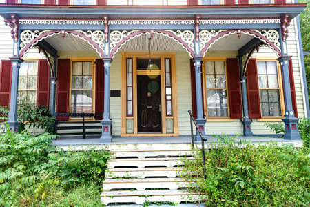 Carved, beautiful facade of an old house and old wooden door in the old town. Copper elements and painted doorway.の写真素材
