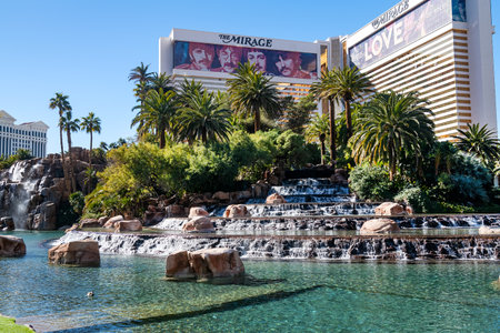 Waterfall and pond with palm trees next to the Mirage Hotel and Casino on the Strip in Las Vegas,...