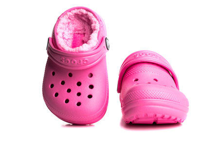 Pink baby sandals CROCS with soft insole isolated on white background. close-up.のeditorial素材