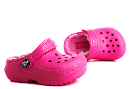 Pink baby sandals CROCS isolated on white background. close-up.のeditorial素材
