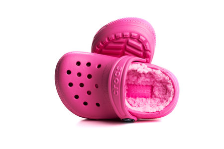 Pink baby sandals CROCS with soft insole isolated on white background. close-up.のeditorial素材