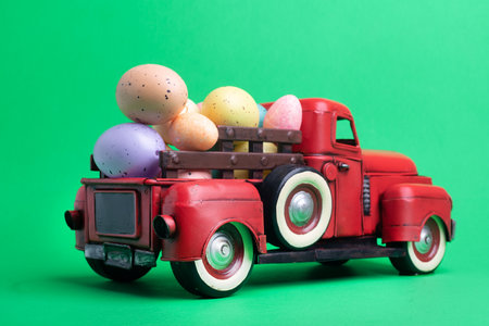 Red truck carrying Easter eggs on a green background, space for text.