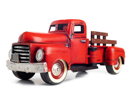 Old truck close-up. Red, vintage, toy truck isolated on white background.の写真素材