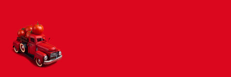 red truck delivers fresh tomatoes. Vintage red toy truck on a red background.Baner, space for text.の写真素材
