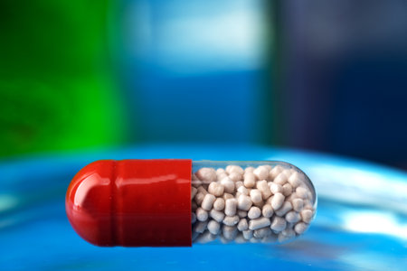 Pill on a glassy blue table. Reflection in glass. close-up. Space for text.