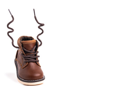 Running children's boot with flying laces isolated on white background. Space for text.の写真素材