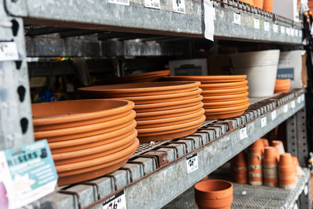 variety of clay flower pots with price tags on the shelves in a garden store.の写真素材