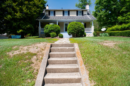 modern house and a long stone path with steps between the bushes and the lawn.のeditorial素材