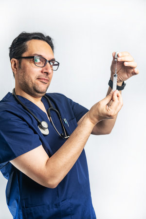 Cheerful Doctor draws a vaccine into a syringe and is ready to make injectionの写真素材