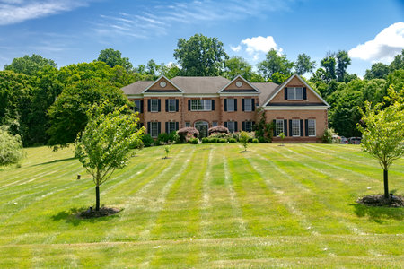 large country house in the English style with a large mowed lawn in front of the entrance.のeditorial素材