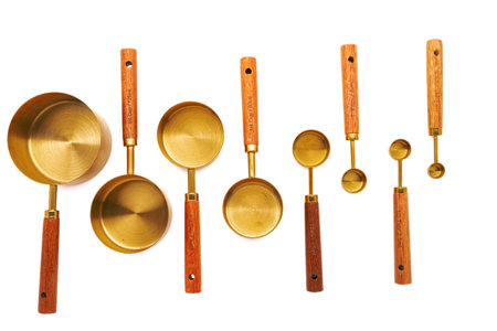 Copper Measuring spoon set with Wooden Handles on white background.の写真素材