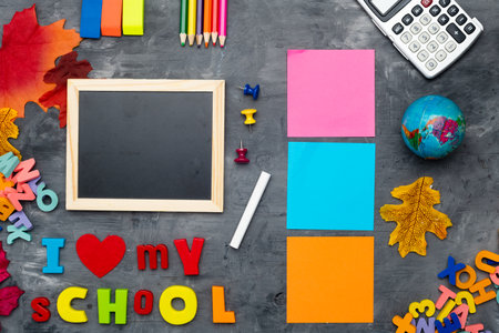 School supplies, colored letters, a globe and a school board with the inscription I LOVE MY SCHOOL,...