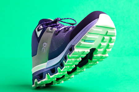 QC sports shoes on a green background close-up. Casual stylish shoes.のeditorial素材
