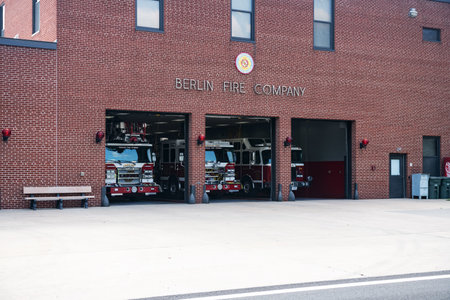 Fire station in a small town Berlin in Maryland USA. Three fire trucks are in the open garage.のeditorial素材