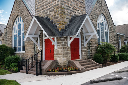 Entrance red doors to a large stone church.の写真素材