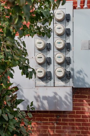Electric Meters For Apartments are located on the wall outside the building. Close-up.のeditorial素材