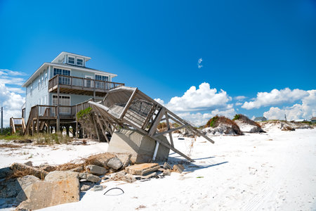 house on stilts with a broken pier on the Atlantic Ocean in North Carolina.の写真素材