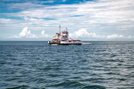 ferry with cars sails through a strait in the Atlantic Ocean.