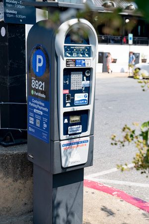 Parking machine in the city street. Parking system with payment in a mobile application and bank cards.のeditorial素材