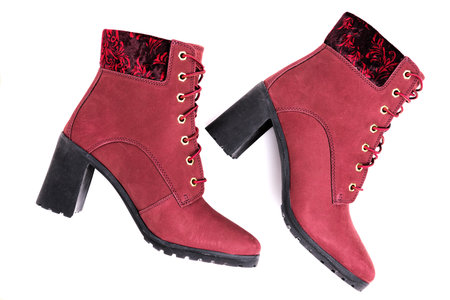 Women's ankle boot with nubuck leather cherry color isolated on white background. Close-up.