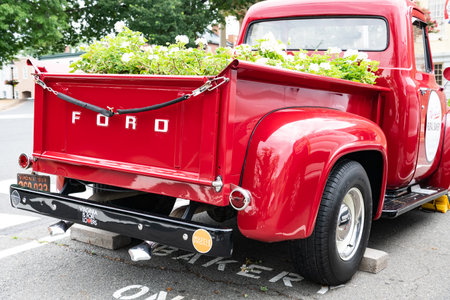 Restored red pickup truck from the 50s, Ford F100 in the parking lot. Back view.のeditorial素材