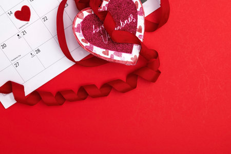 February 14 is marked on the Calendar and a heart is a gift. Valentine's Day is marked on the calendar with a red heart. Space for text.の写真素材