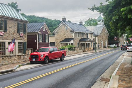 Ford F-150 pickup truck is parked on the side of the road in an ancient city.
