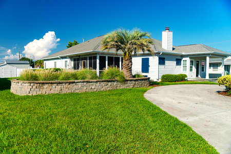 Nice oceanic style house with palm tree and lawn near the Atlantic Ocean.のeditorial素材