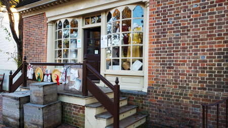 Main entrance door to store. Exterior view of a small storefront with steps at the entrance.