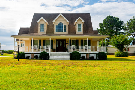 Residential two-story detached house with green lawn in frontのeditorial素材