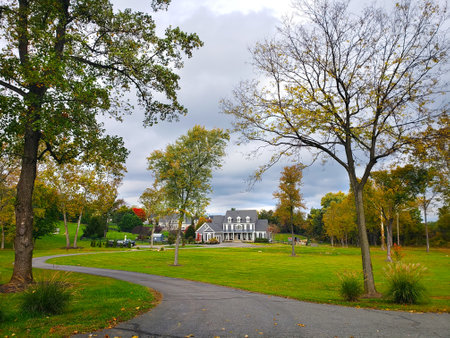 Large country house. Autumn landscape with a large trimmed lawn.の写真素材