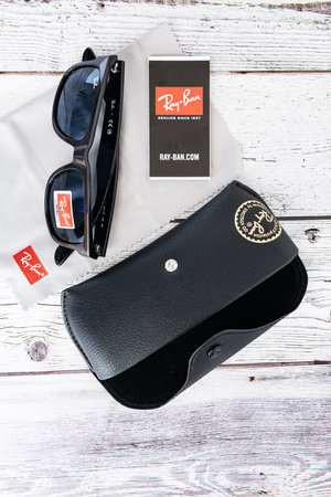 Ray Ban sunglasses and leather glasses case with brand logo.