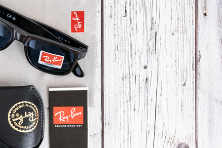 Ray Ban sunglasses and leather glasses case with brand logo.