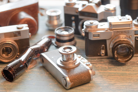 collection of vintage cameras displayed on wooden shelf. selective focusのeditorial素材