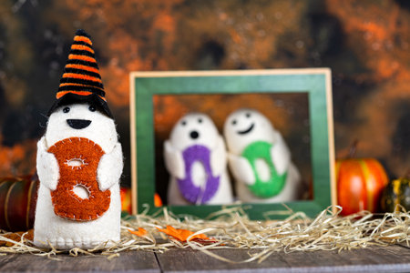 cheerful family of ghost dolls with the word Boo and pumpkins ready for Halloweenの写真素材