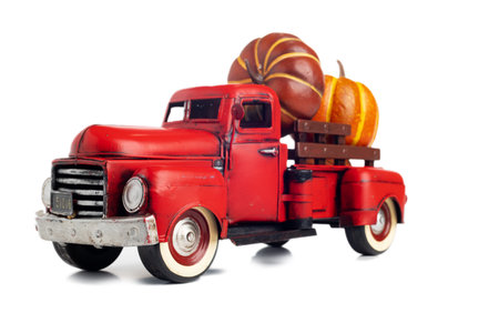 Red vintage truck with pumpkins on white background. Pumpkins for Thanksgiving holiday.の写真素材