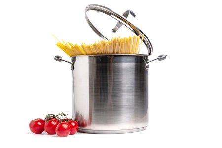 Tall stainless steel pot with pasta and tomatoes on white background.の写真素材