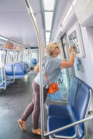 Woman studying the scheme of the Washington Metro on the Washington-Ashburn branch in the state of...