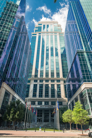 The Bank of America Tower against a blue sky in Charlotte's business district