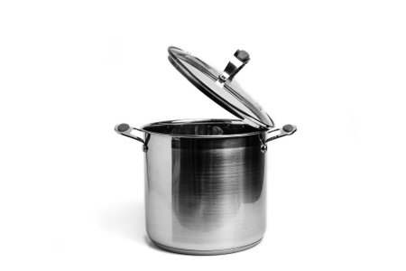 Tall stainless steel pot with glass lid is insulated on a white background.の写真素材