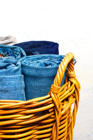 wicker basket with various jeans inside.の写真素材