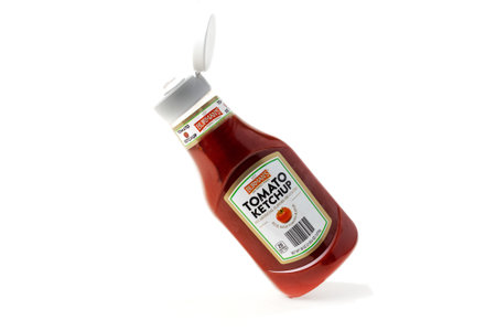Bottle of tomato ketchup on white background.