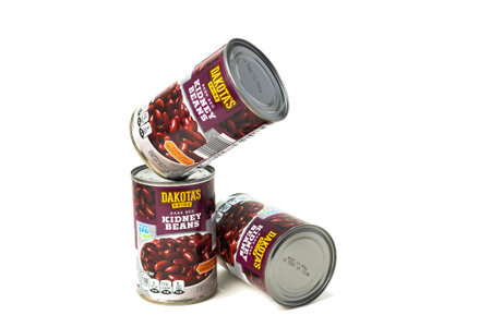 Three cans of DAKOTA'S canned dark red beans on white background.