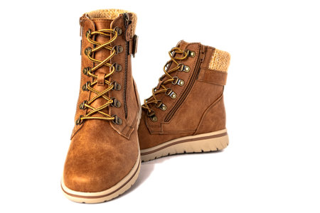 Women's brown leather demi seasonal boots with laces and zipper. on white background.