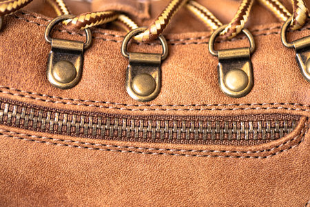 Close-up of laces and zipper on brown leather shoeの写真素材