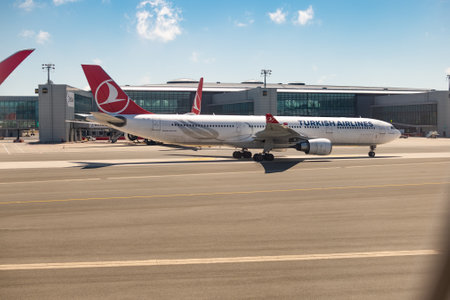 An airliner with Turkish airlines emblem on an airfield runwayのeditorial素材