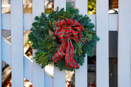 Traditional Christmas wreath on the front wooden door of a vintage house.の写真素材